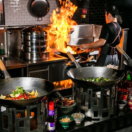 Qt Queenstown Exteriör bild A wok being used in a restaurant kitchen